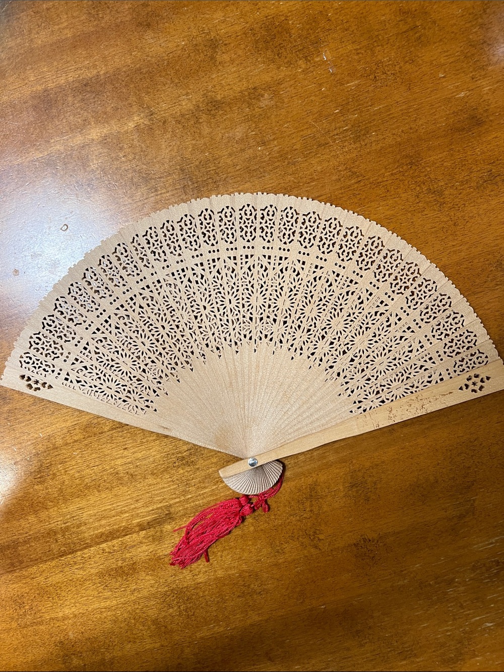 Handmade Sandalwood Folding Fan with Red Tassel - Elegant Lace Cut Design
